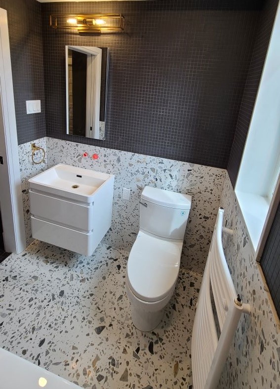 Rob and Lisa Jefferson Finish renovation of their new bathroom and shower with black floor tile