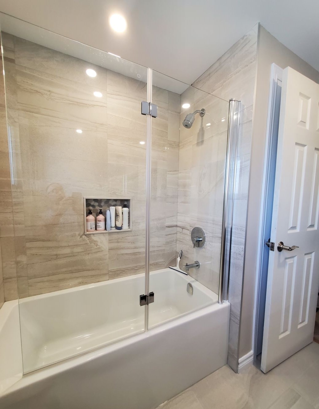 Allen McMillen finished renovation of their bath and shower with large beige towers